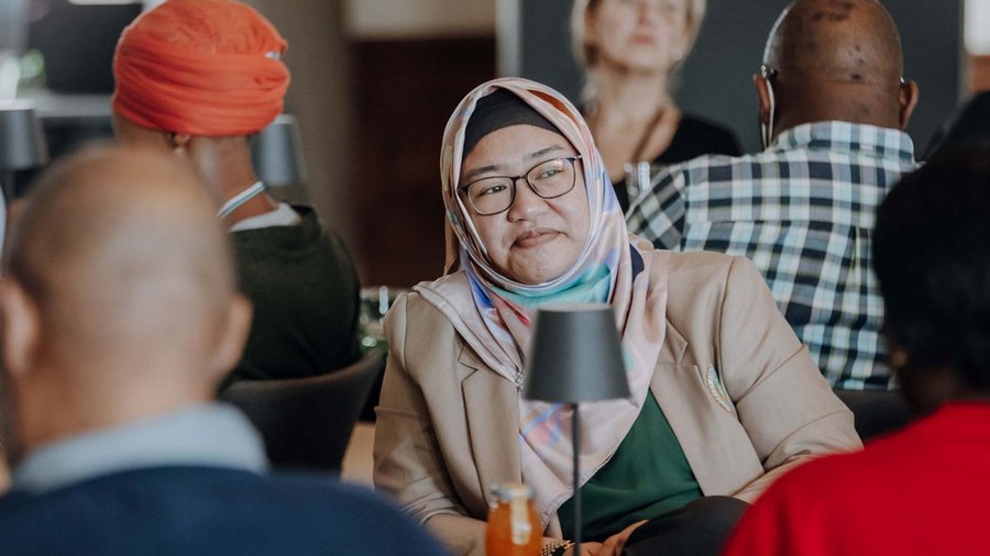 A photo of Elijah in conversation at Salzburg Global Seminar in 2022