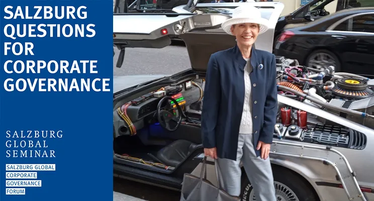 Isabella D. Bunn next to a DeLorean outside the theater showing Back to the Future