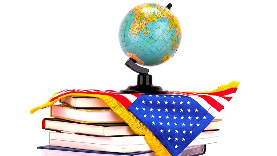 an image of a globe on top of an american flag over a stack of books