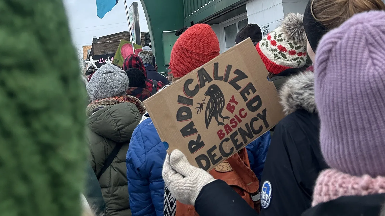 photo of protest in minneapolis with poster reading "Radicalized by basic decency"