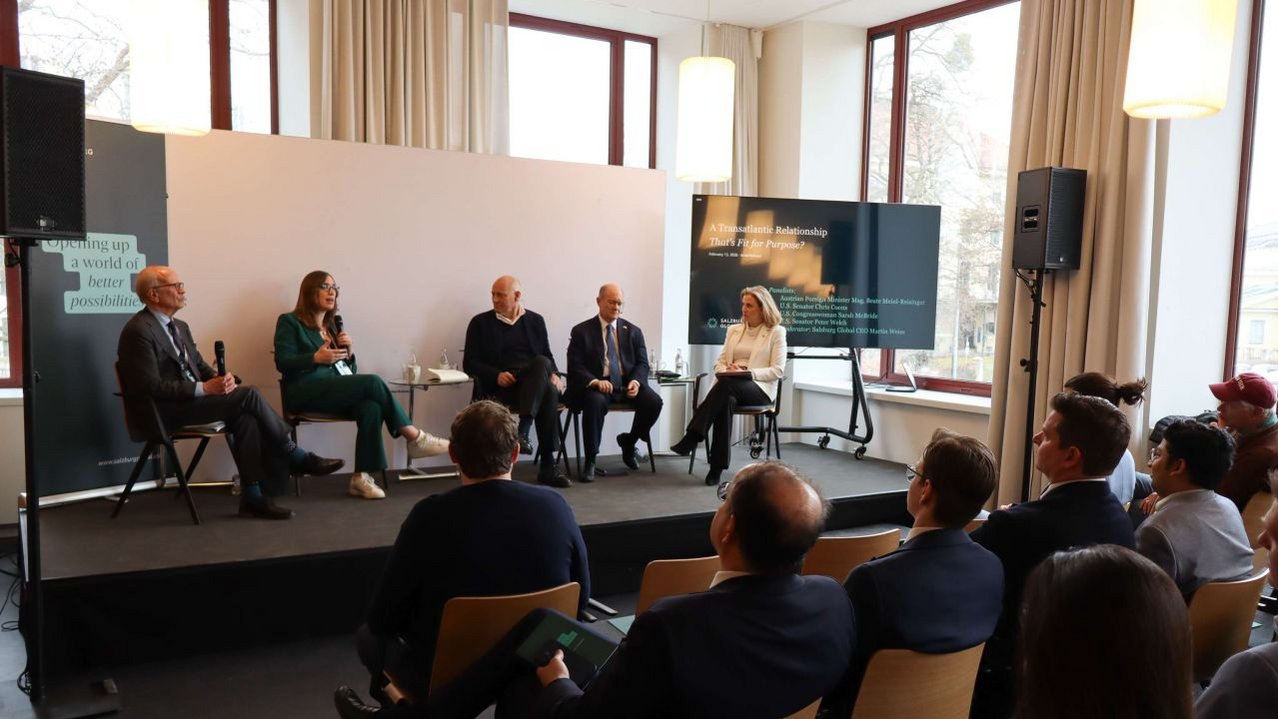 an image of a panel discussion with several people seated on a stage in front of an audience at Amerikahaus Munich