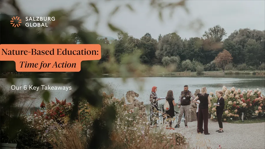 A group of Salzburg Global Fellows stand on the Mansbach Garden Parterre of Schloss Leopoldskron