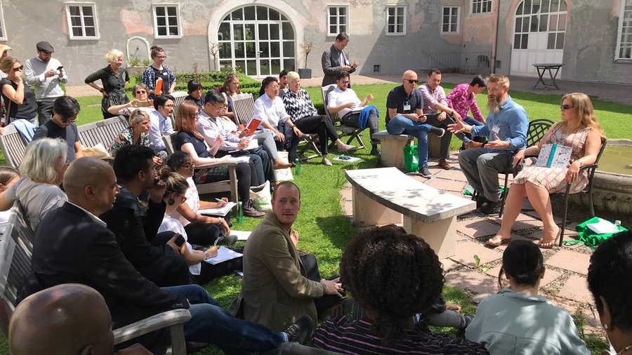 Participants move their group work outdoors and hold a discussion in the Haaga Courtyard
