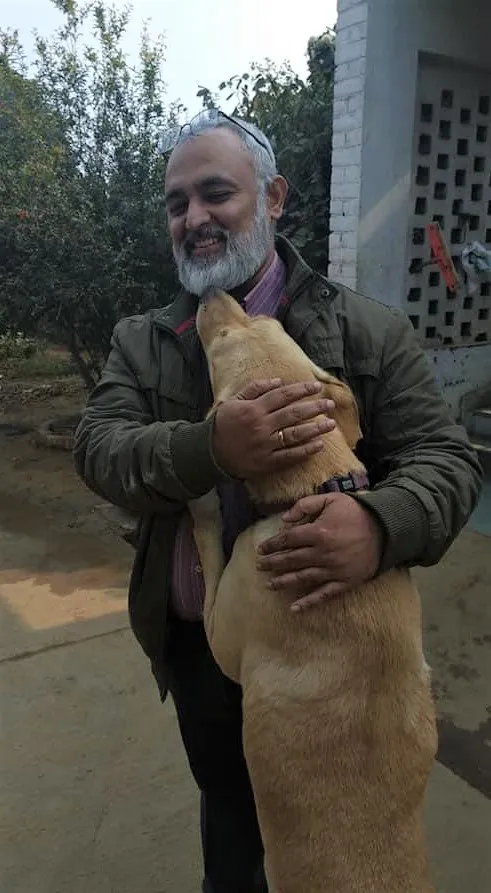 Man Hugging a Dog