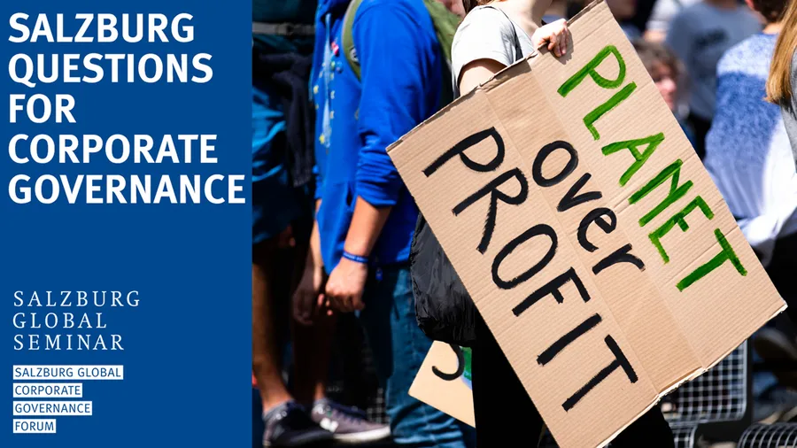 Person with sign that says "Planet over Profit"