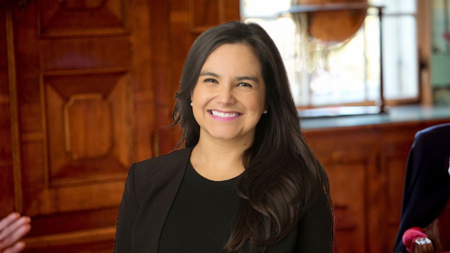 a headshot of a woman juxtaposed over a background of a room