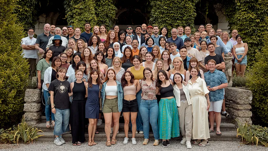 A group of Media Academy participants stand in front of the Schloss.