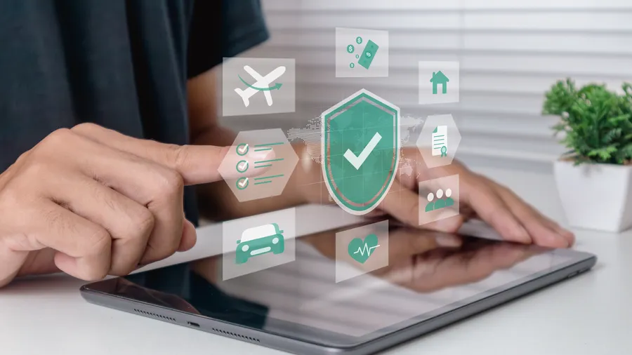 an image of a man selecting online insurance options with a tablet