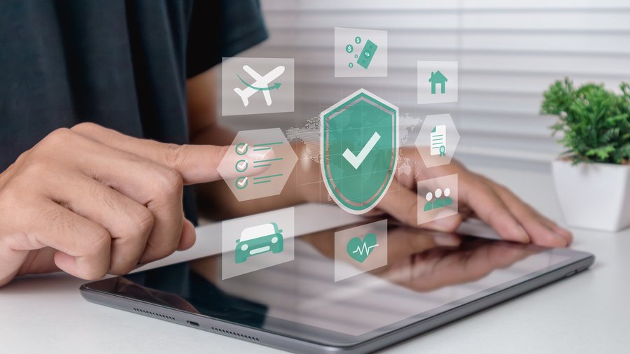 an image of a man selecting online insurance options with a tablet