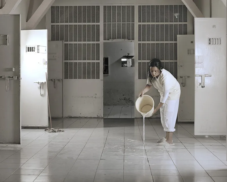 Woman spilling water out of a bucket
