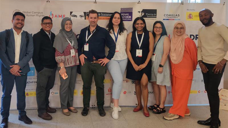 A group of Salzburg Global Fellows stand together smiling at the 5th World Congress on Justice With Children in Madrid, Spain in June 2025.
