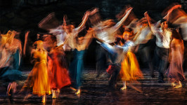 a group of blurry dancers on a stage