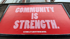 A poster that reads "Community is strength."