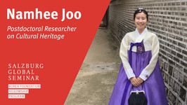 Namhee standing in front of a stone wall in traditional Korean clothing
